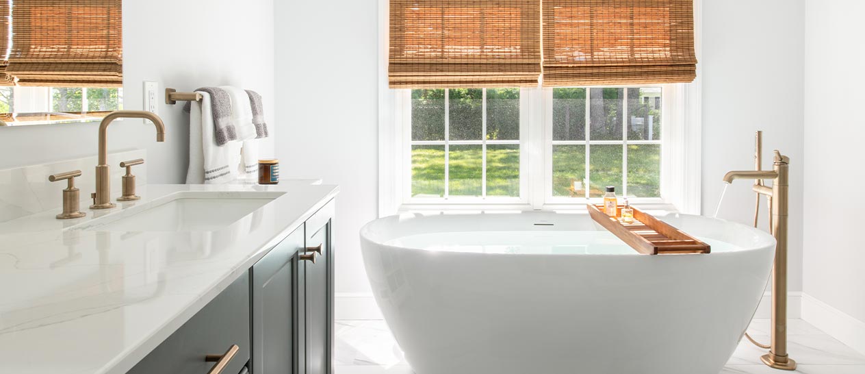 Cape Cod bathroom renovation with large soaking tub and bronze hardware